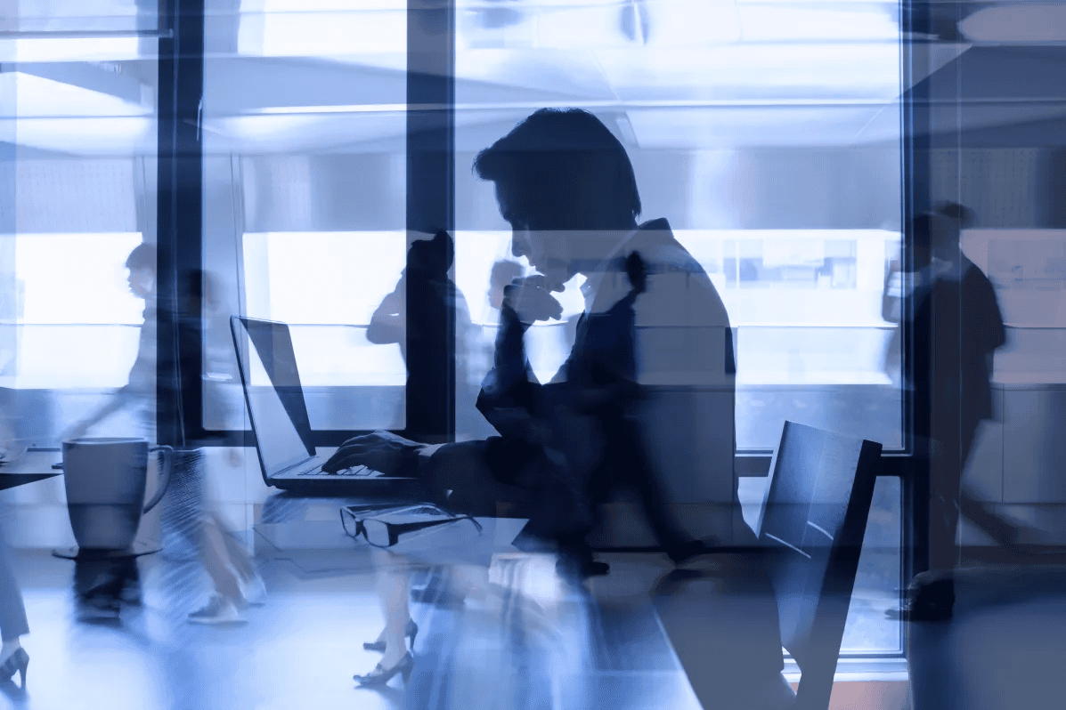 Blurred Office Silhouettes for What does an Investment Banker do?