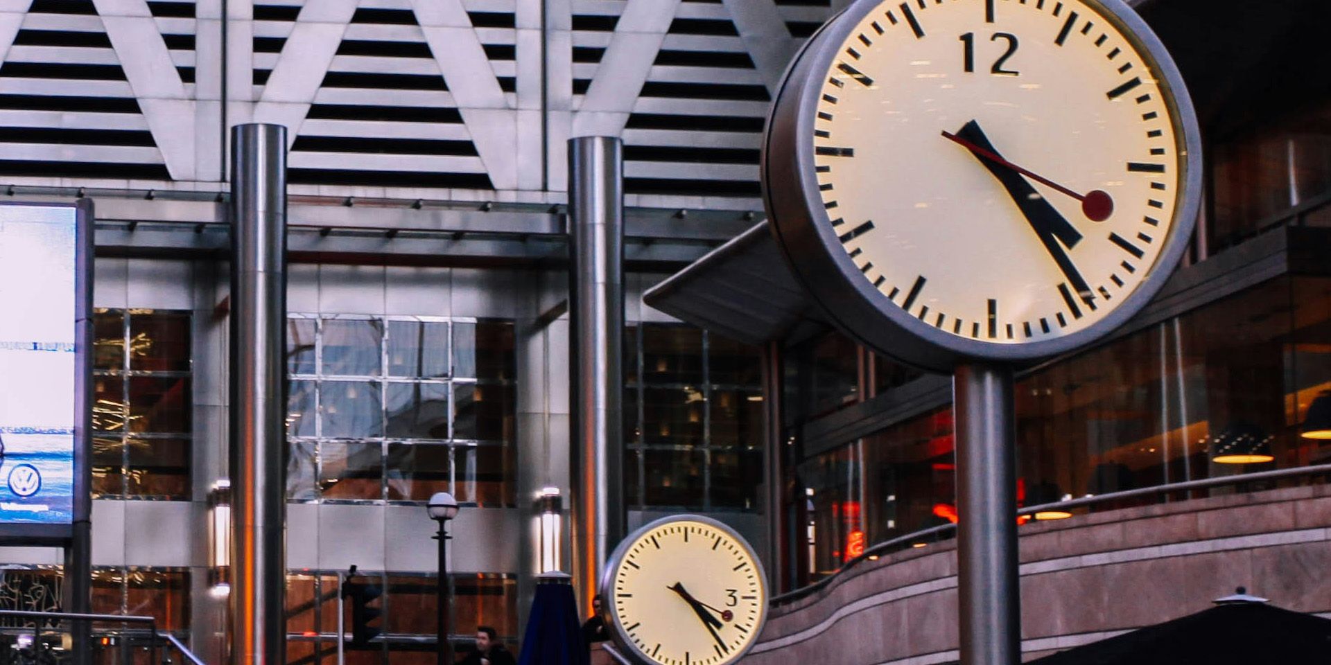 Clocks at Modern Transit Station for A Day in the Life of an Investment Banking Analyst