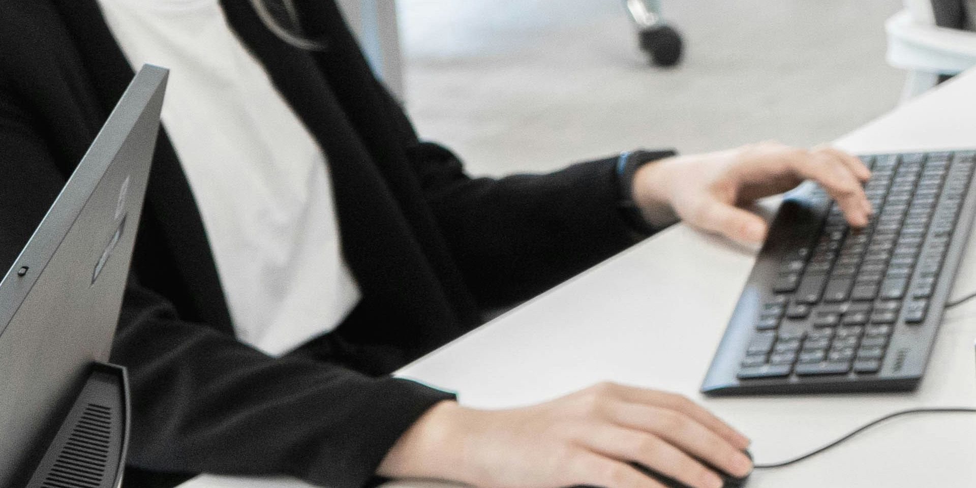 Professional working at computer for Wealth Management vs. Private Equity: Which Financial Career Fits You Best?