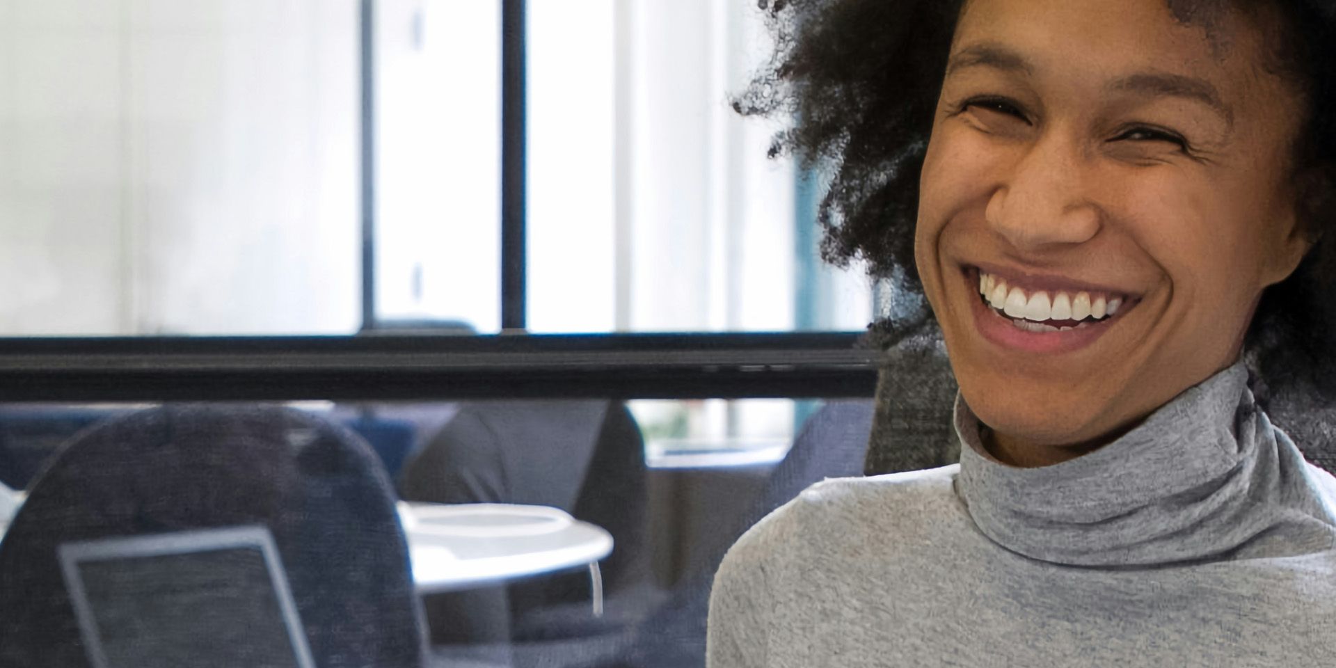 Smiling woman in office for Begin Your Career in Asset Management: Roles, Skills, and Growth Paths